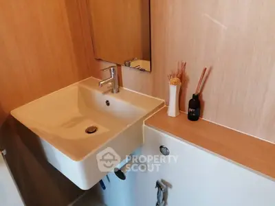 Modern bathroom with stylish sink and wooden accents