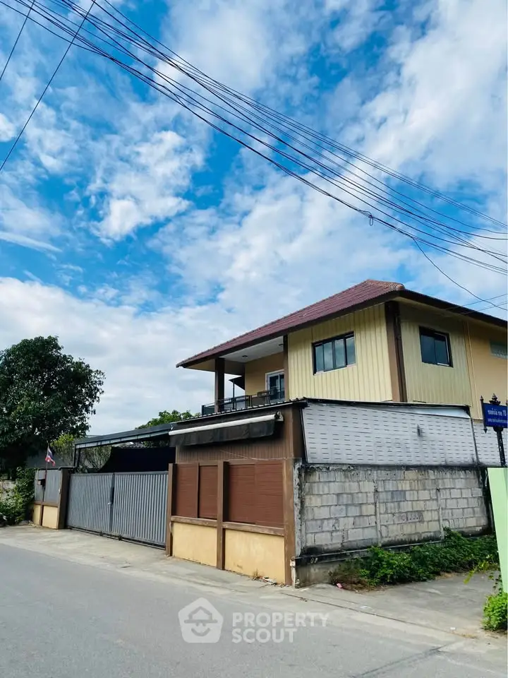 Charming two-story house with a spacious balcony and modern design, perfect for family living.