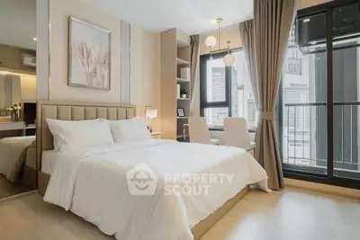 Modern bedroom with elegant decor, large window, and city view, featuring a cozy bed and stylish furnishings.