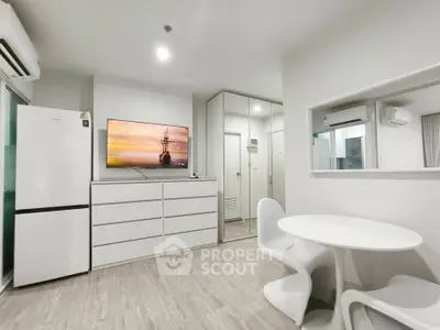 Modern minimalist living room with sleek furniture and built-in storage solutions.
