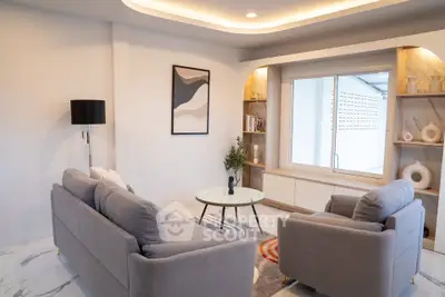 Modern living room with stylish furniture and elegant decor, featuring a cozy seating area and contemporary artwork.