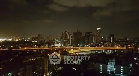 Stunning nighttime cityscape view with illuminated skyline and highway