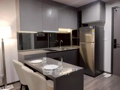 Modern kitchen with sleek gray cabinets and stainless steel appliances