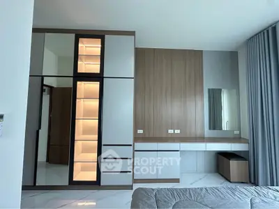 Modern bedroom with sleek wardrobe and stylish vanity area