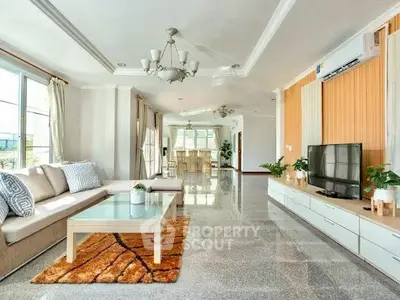 Spacious modern living room with elegant decor and abundant natural light.