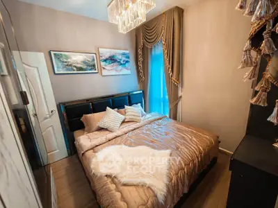 Luxurious bedroom with elegant decor and plush bedding, featuring a stylish chandelier and framed art.
