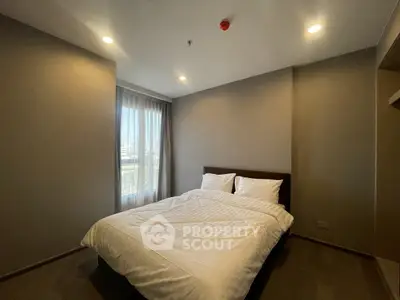 Cozy bedroom with natural light and modern design in a stylish apartment.