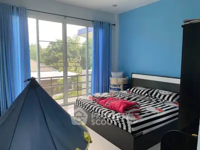 Bright bedroom with large windows and modern decor