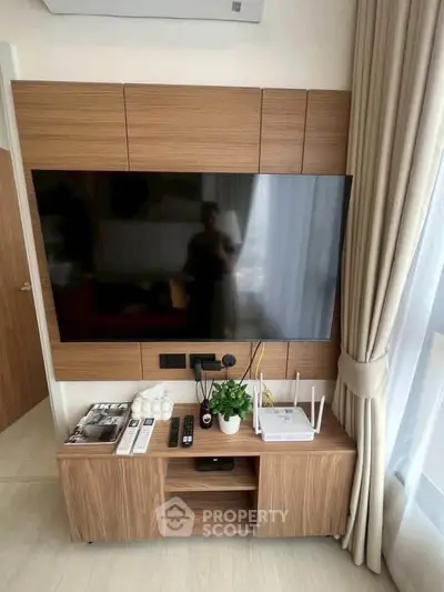 Modern living room with sleek TV setup and stylish wooden cabinetry