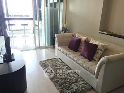 Cozy living room with plush sofa and modern decor, perfect for relaxation.