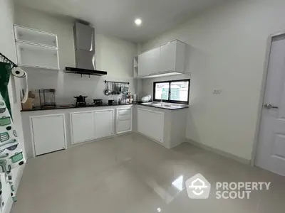 Modern kitchen with sleek cabinetry and gas stove in a bright, spacious layout.