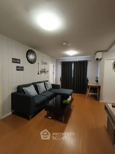 Modern living room with stylish decor and comfortable seating in a cozy apartment.