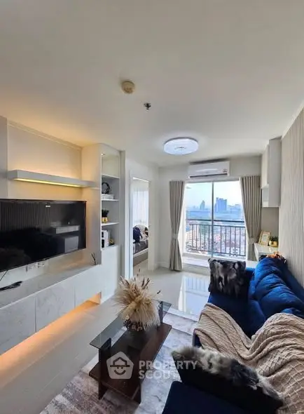 Modern living room with city view, stylish decor, and cozy seating area.