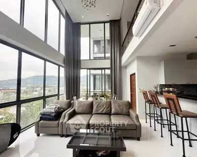 Luxurious modern living room with high ceilings and panoramic windows offering stunning views.
