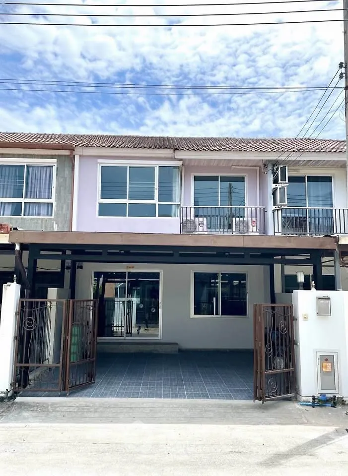 Charming townhouse with spacious driveway and modern facade in a serene neighborhood.