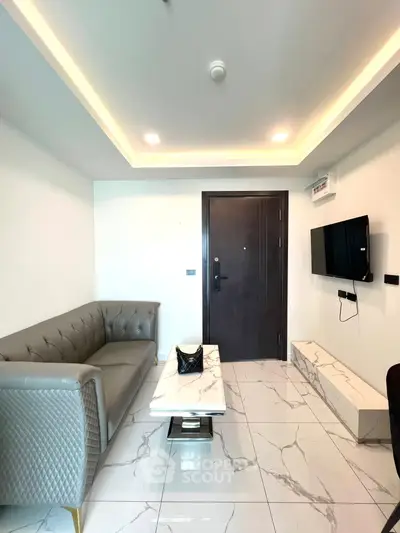 Modern living room with sleek furniture and marble flooring