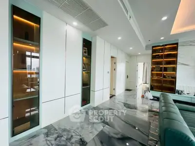 Luxurious modern living room with sleek marble flooring and elegant built-in cabinets.