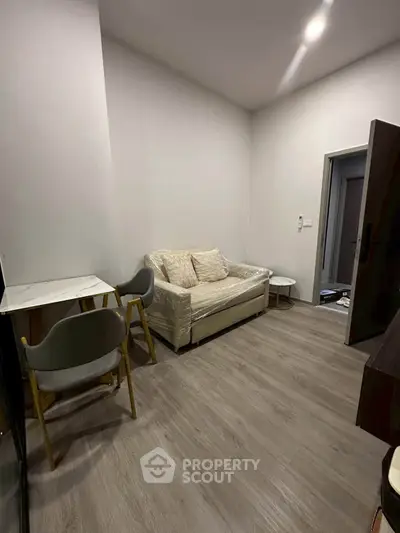 Cozy living room with modern furniture and stylish flooring, perfect for relaxation and entertaining guests.