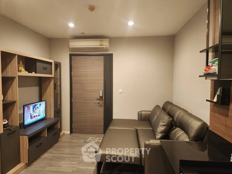 Modern living room with sleek furniture and wall-mounted TV, perfect for cozy relaxation.