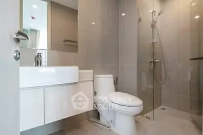 Modern bathroom with sleek fixtures and glass shower enclosure