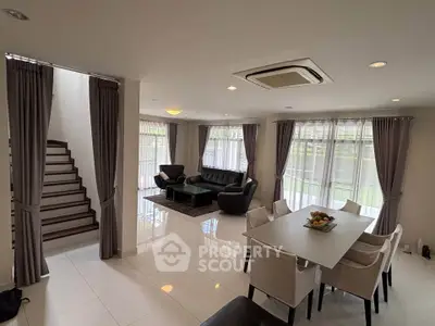 Spacious modern living room with elegant dining area and natural light