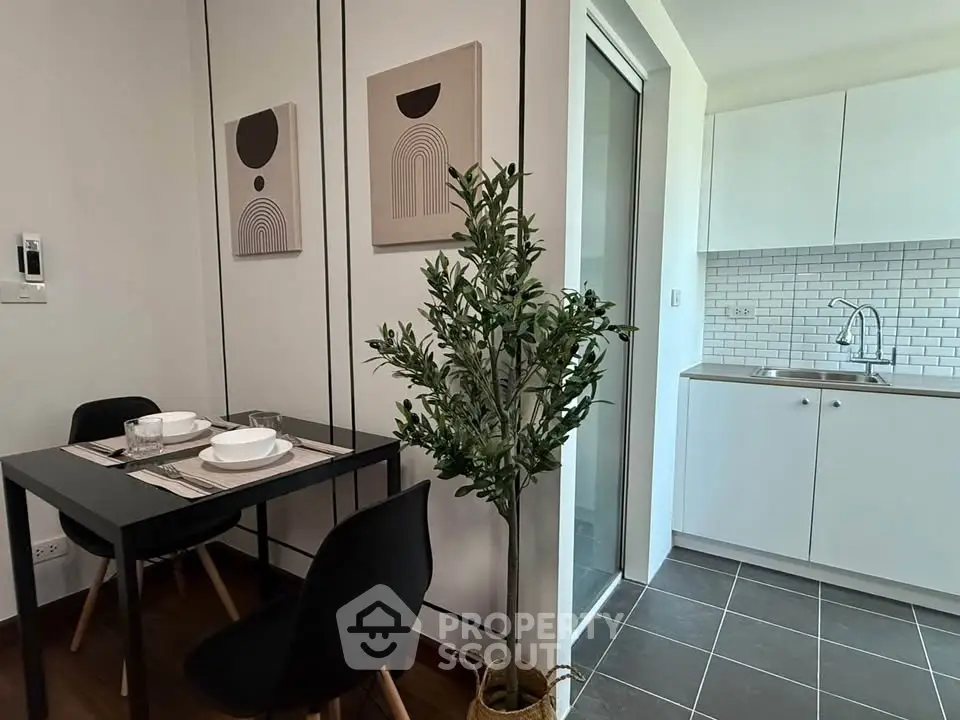 Modern dining area with sleek kitchen in stylish apartment