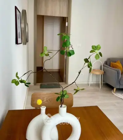 Stylish modern living room with minimalist decor and elegant wooden table centerpiece.