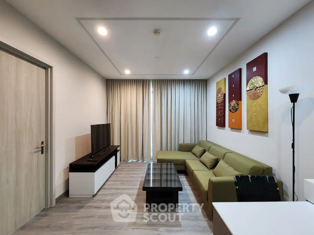 Modern living room with stylish decor and comfortable green sofa