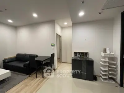Modern living room with sleek black furniture and minimalist decor