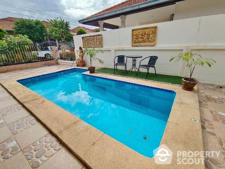 Charming villa with private pool and cozy outdoor seating area, perfect for relaxation and entertaining.