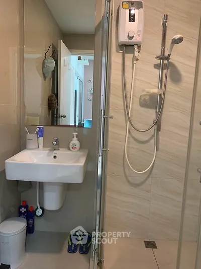 Modern bathroom with shower and sink in stylish apartment
