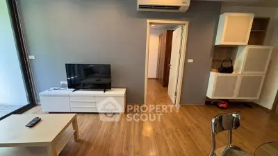 Modern living room with wooden flooring and sleek furniture