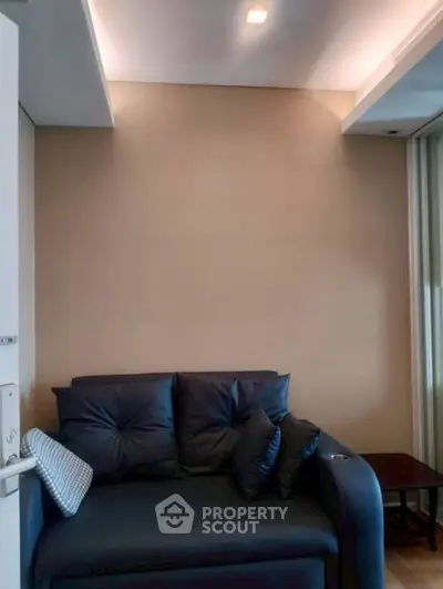 Cozy living room with modern dark sofa and ambient lighting