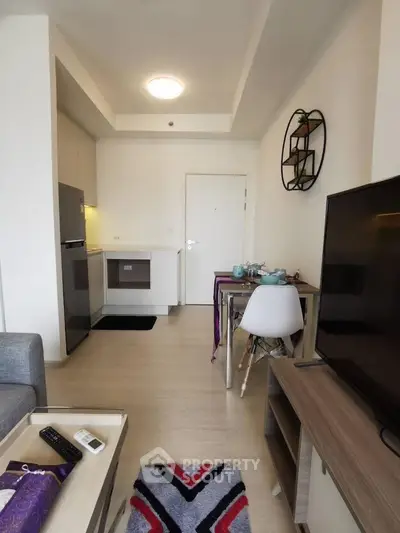 Modern studio apartment with open kitchen and cozy living area, ideal for urban living.