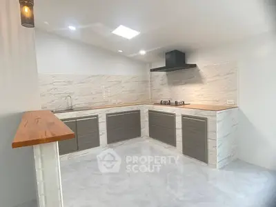 Modern kitchen with sleek cabinets and gas stove in open layout