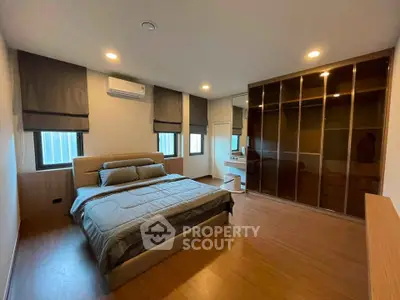 Spacious bedroom with modern design and ample natural light