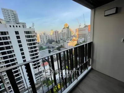 Stunning cityscape view from modern high-rise balcony at sunset.