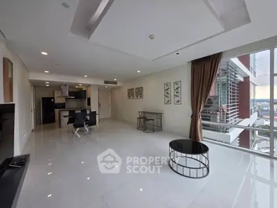 Spacious modern living room with open kitchen and stunning city view