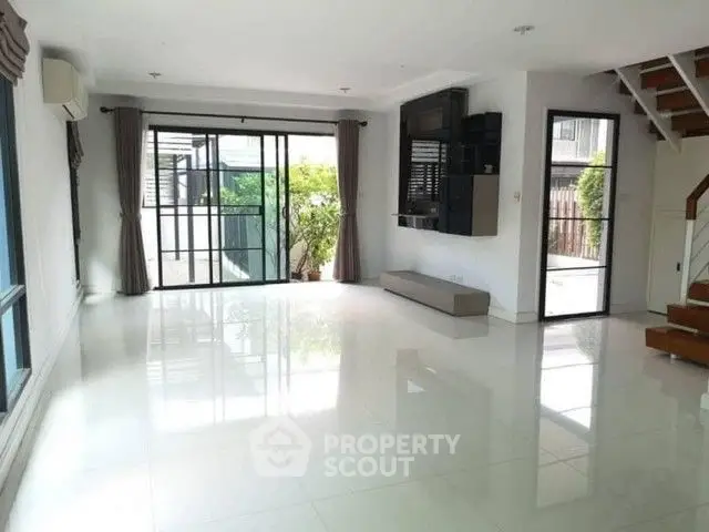 Spacious modern living room with large windows and sleek design
