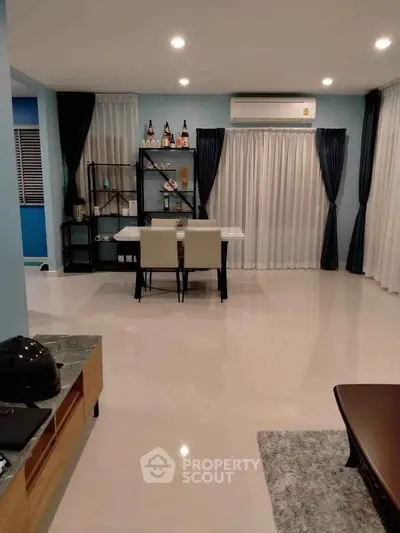 Spacious modern living room with elegant dining area and stylish decor.