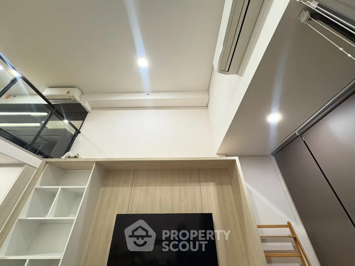 Modern living room with high ceiling and built-in shelving