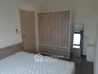 Modern bedroom with minimalist design and wooden wardrobe
