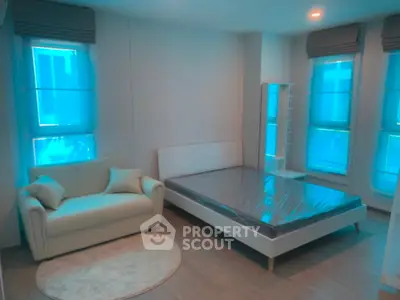 Modern bedroom with stylish furniture and large windows in a contemporary apartment.