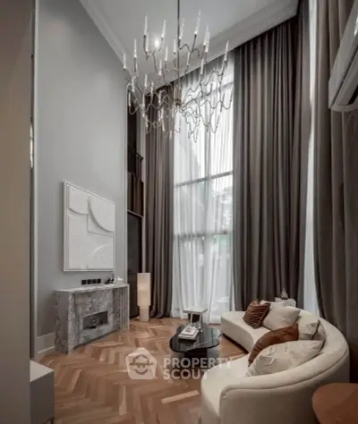 Luxurious high-ceiling living room with elegant chandelier and modern decor