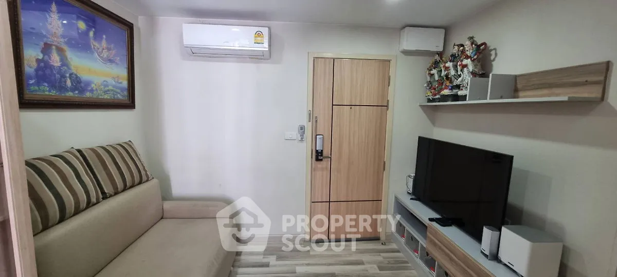 Cozy living room with modern decor, air conditioning, and entertainment setup.