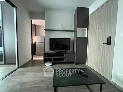 Modern living room with sleek furniture and open kitchen view, perfect for urban living.