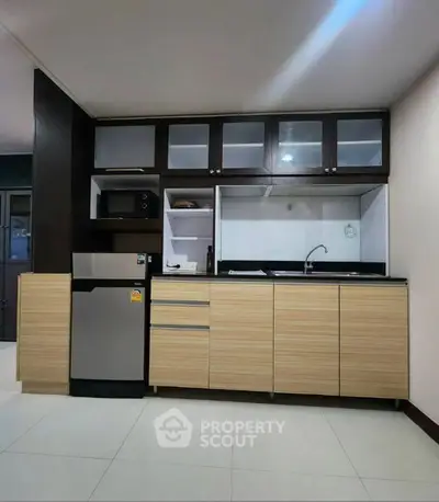 Modern kitchen with sleek cabinetry and stainless steel appliances in a stylish apartment.