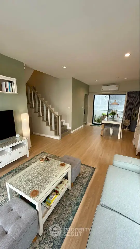 Spacious modern living room with stylish decor and open layout, featuring a cozy seating area and dining space.