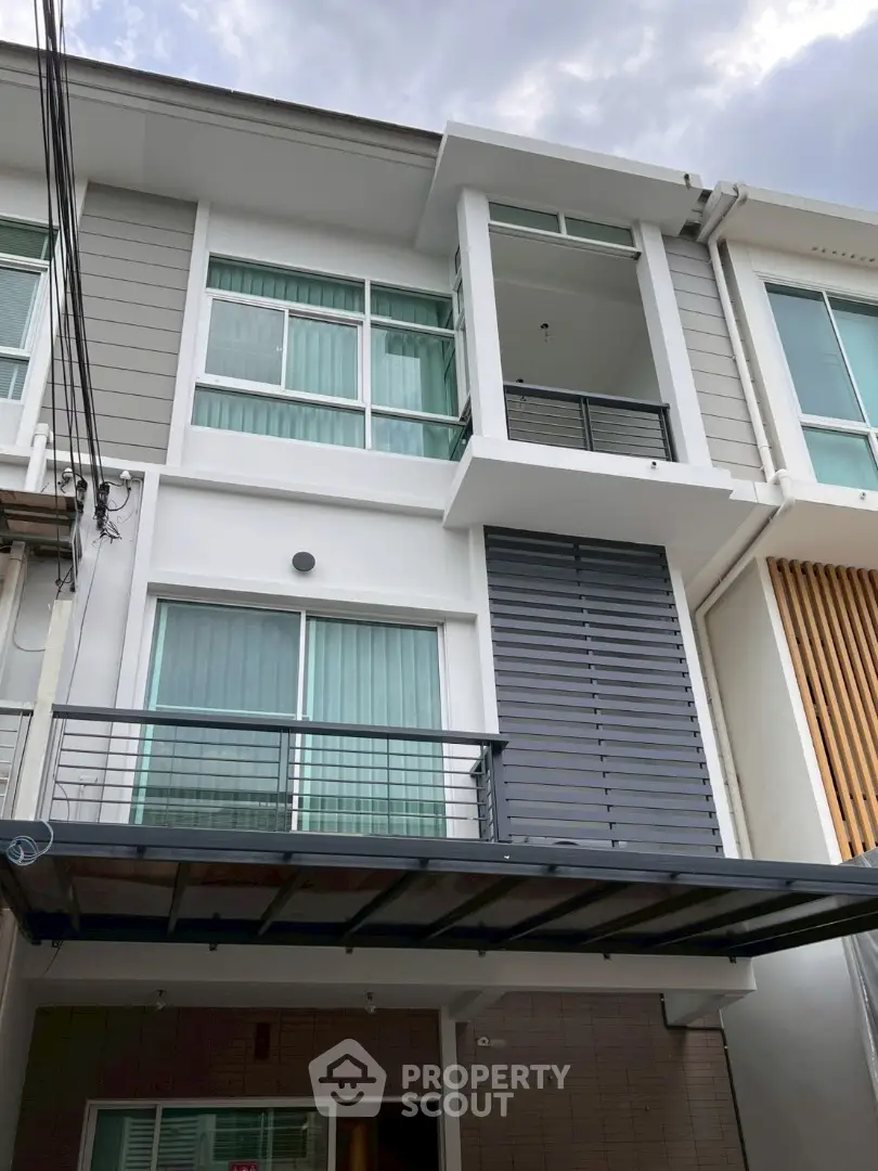 Modern townhouse exterior with sleek design and large windows