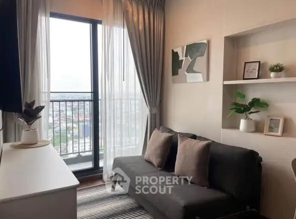 Cozy living room with balcony and city view, modern decor and natural light.